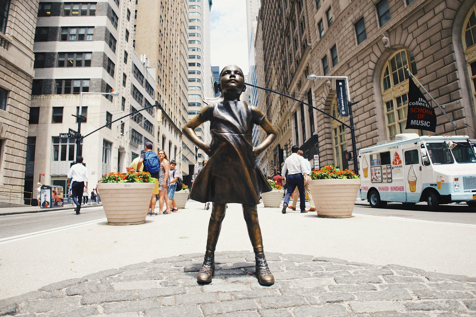 The Fearless Girl statue standing on a street in New York's Financial District